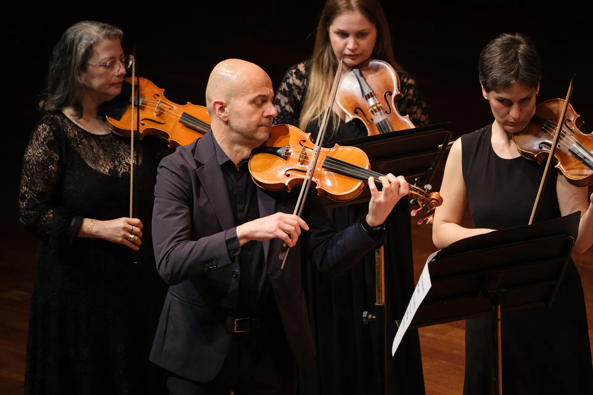 Accademia Bizantina violinists in concert, photographed up close.