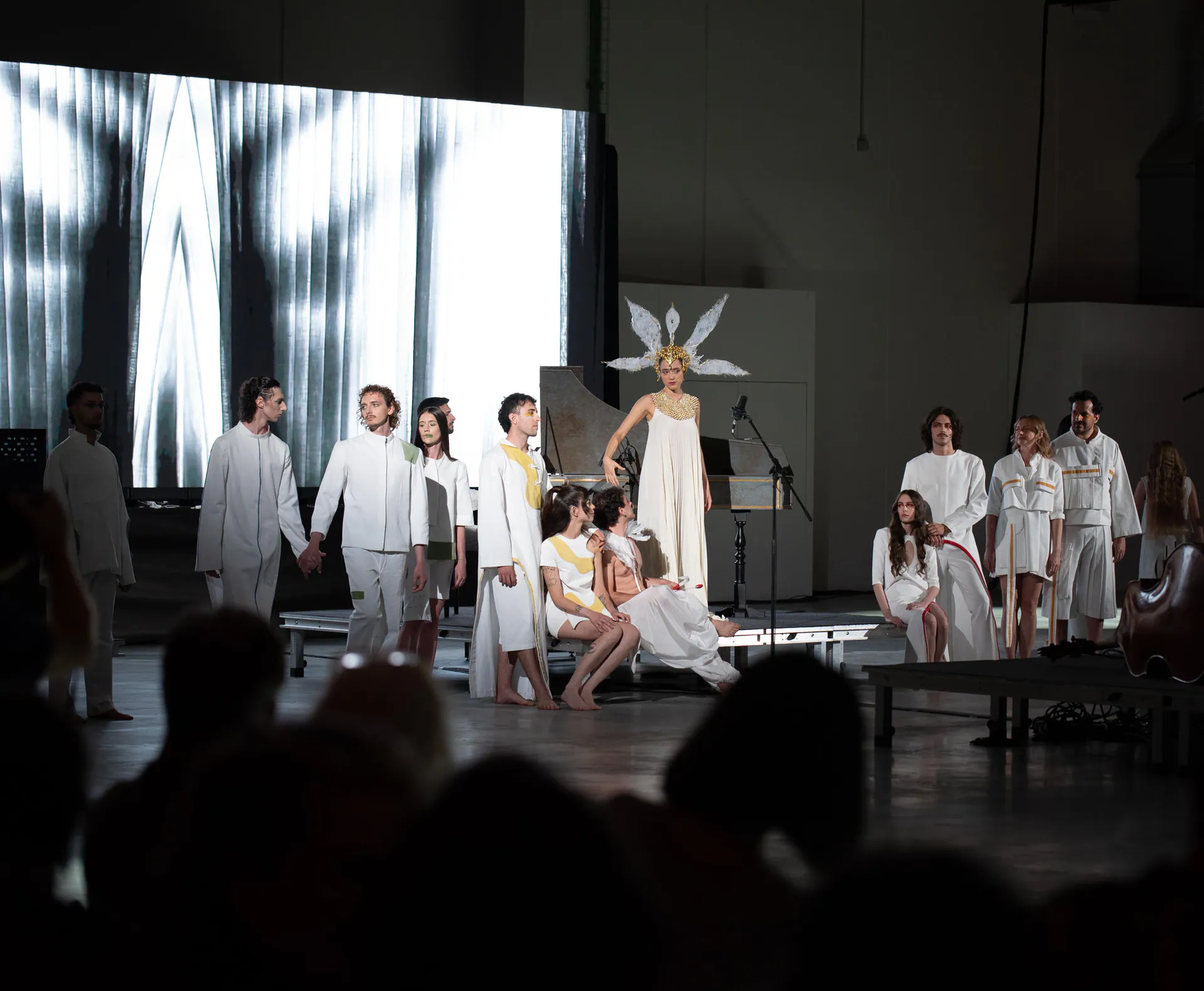 The ARWE 2026 fashion show at SET Scalo Eventi Torino, with models in white in front of the visual backdrop on the LED wall
