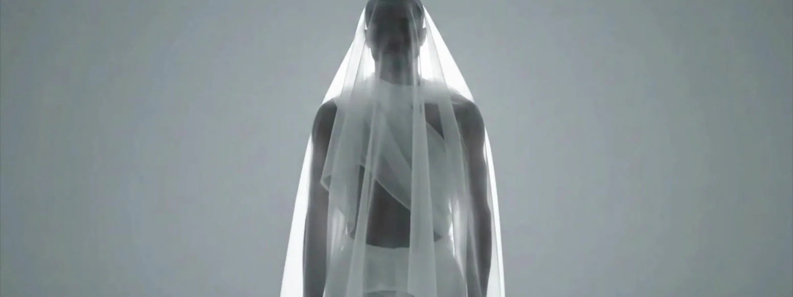 Backdrop frame: a veiled figure in white