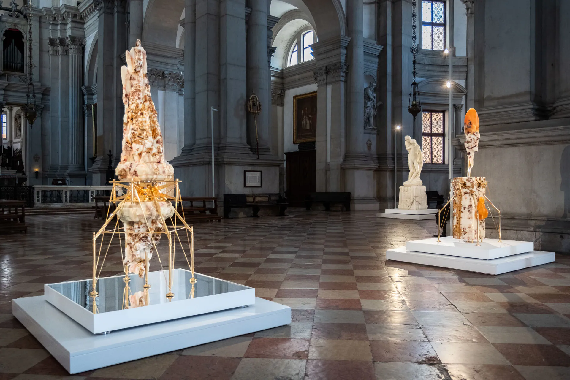Two sculptures by Barry X Ball on mirrored plinths in the nave of the Basilica of San Giorgio Maggiore.