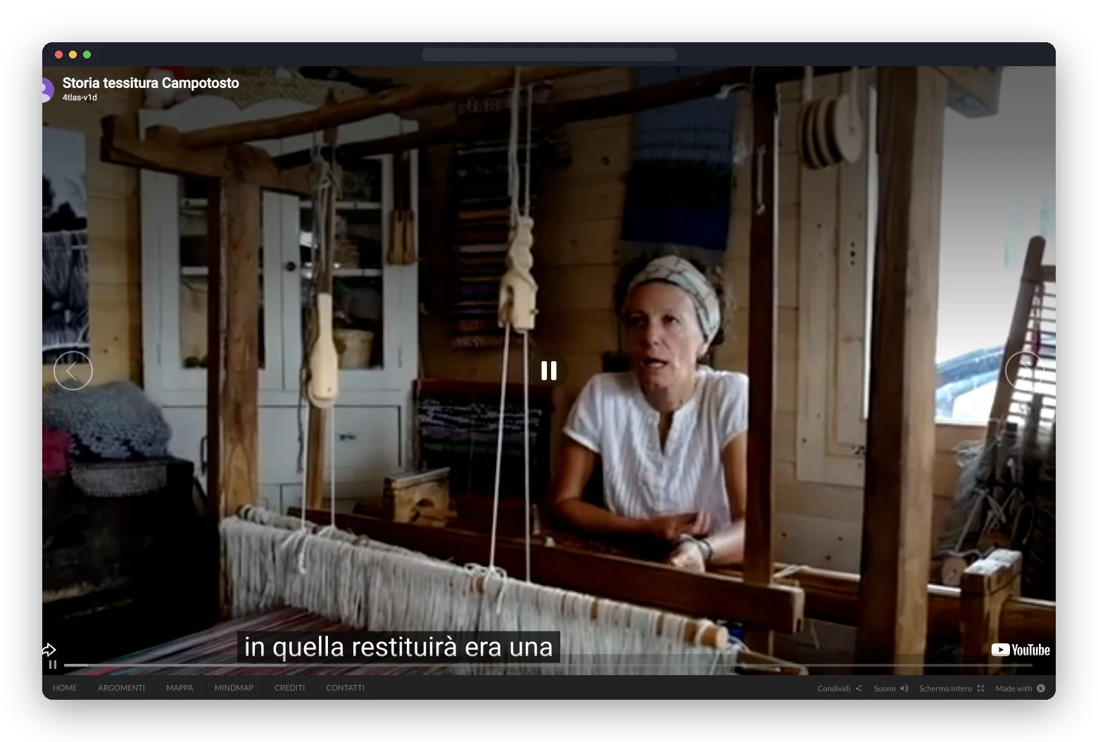 Screen of the interactive documentary: a video of Assunta seated at the loom, with subtitles