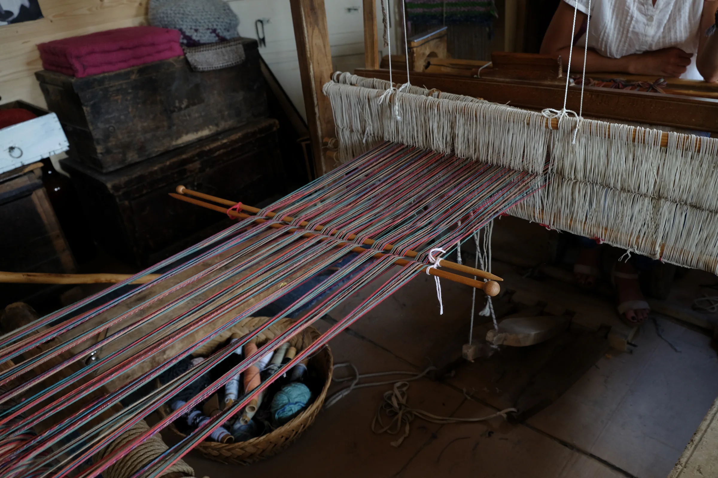 Coloured threads stretched on the wooden loom in Assunta’s workshop