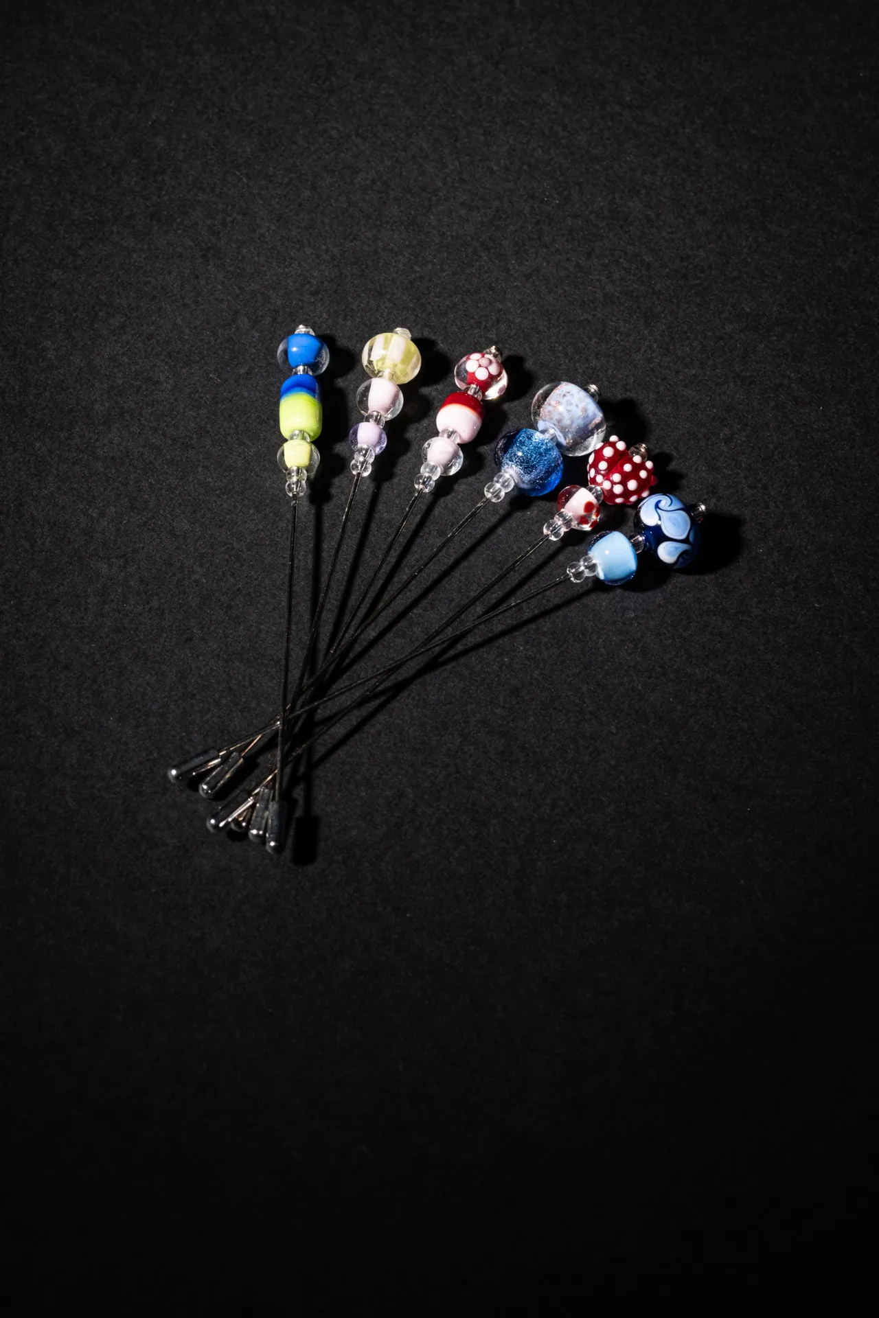 Hat pins with coloured glass beads made by the young artisans